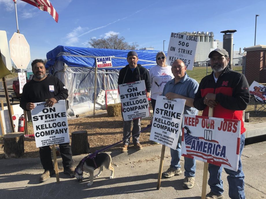 Striking Kellogg's workers Michael Rodarte, Sue Griffin, Michael Elliott, Eric Bates and Mark Gonzalez stand outside the Omaha, Neb., cereal plant Thursday, Dec. 2, 2021.