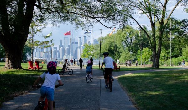 Family biking through a park