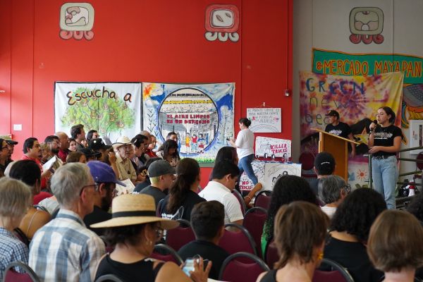Ana Fuentes speaks on stage to a crowd of people