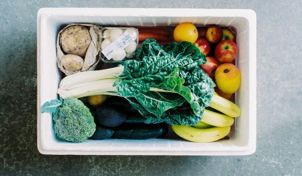 White box filled with fruits and vegetables